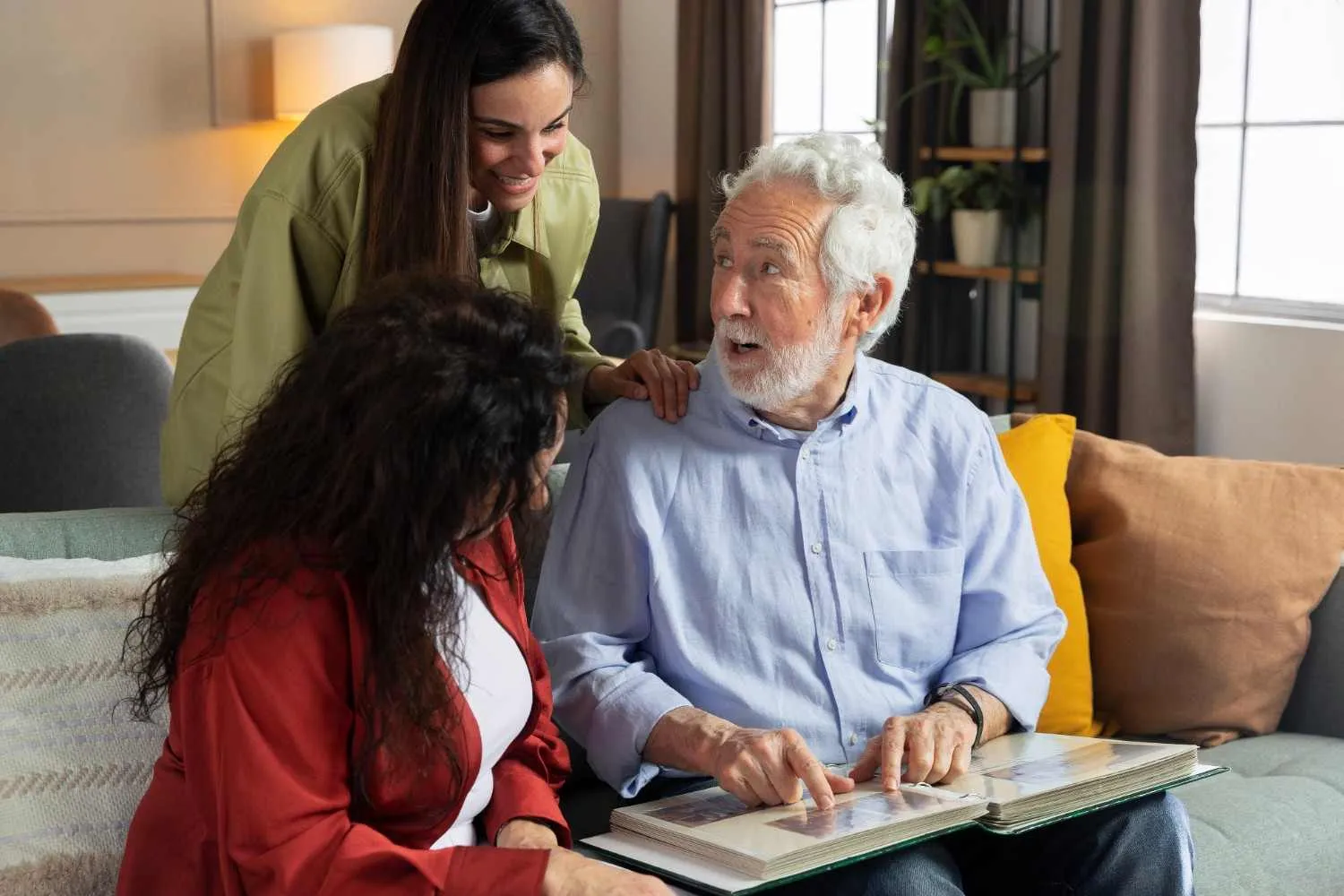 Two women and an older man reading through coverage pages together at home